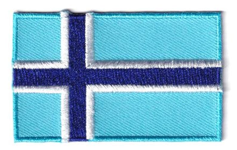 Svalbard flag patch, 6.5 x 4 cm, blue and white embroidered design.