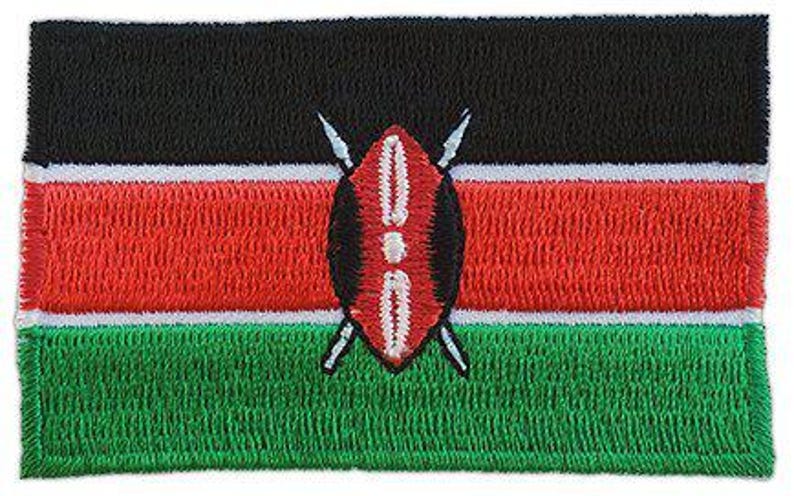 Kenya flag patch featuring horizontal black, red, and green stripes, white borders, and a central Masai shield and spears emblem.