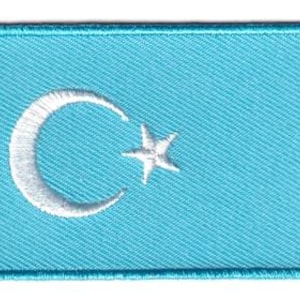 Toppa con la bandiera dell'Oeigoeristan