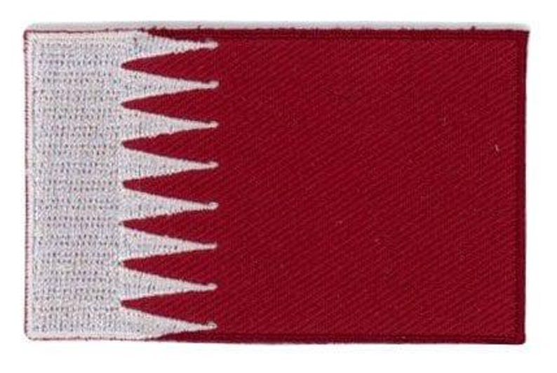 Qatar flag patch with maroon base and white serrated stripe, size 6.5 x 4 cm.