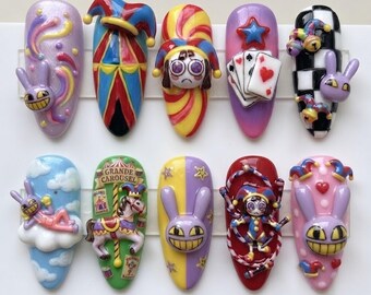 May include: A set of ten almond-shaped press-on nails featuring 3D designs inspired by circus and carnival themes. The collection includes motifs of jester hats, playing cards, a carousel horse with the text GRANDE CAROUSEL, and purple rabbits.