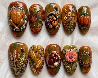 May include: A set of ten press-on nails featuring 3D autumn-themed designs including a roasted turkey, fall leaves, a cornucopia, wildflowers, a pumpkin, wheat stalks, corn cobs, acorns, a slice of pecan pie, a large flower, and a wreath.