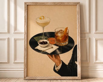 May include: A framed art print depicting a hand in a dark suit sleeve holding a black vinyl record as a serving tray. On the record sits a stemmed cocktail glass, a rocks glass with an orange peel, a small bowl of dark cherries, and a napkin.