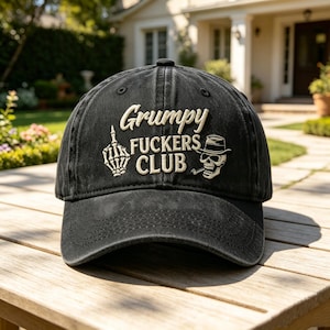 May include: A black baseball cap featuring embroidered white text that reads Grumpy FUCKERS CLUB. The design includes a skeleton hand making a middle finger gesture on the left and a skull wearing a fedora hat and smoking a pipe on the right.