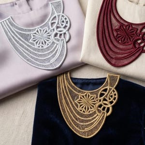 May include: Three shirts featuring intricate, lace-like embroidered collars. One shirt is light lavender with a silver collar, one is cream with a deep red collar, and one is dark navy blue velvet with a metallic gold collar, each with a star motif.