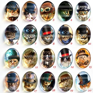 May include: A collection of twenty-five oval glass cabochons featuring digital illustrations of cats wearing various hats, goggles, and monocles. Each cat portrait is numbered from one to twenty-six, excluding twenty-one, and displays unique accessories.