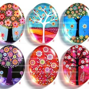 Op de afbeelding: Zes ovale glazen cabochons met kleurrijke boom- en bloemillustraties. Elk stuk toont een uniek artistiek ontwerp met levendige kleuren waaronder roze, blauw, paars, rood en oranje, genummerd van één tot zes voor identificatie.