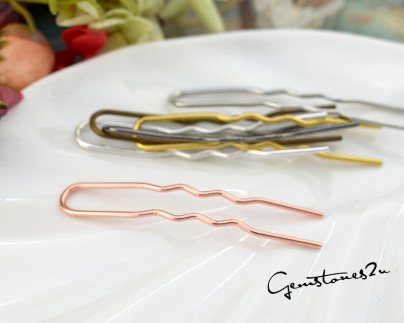 May include: A set of wavy hair pins in gold, silver, and rose gold. The pins are made of metal and have a wavy design. They are perfect for holding hair in place.