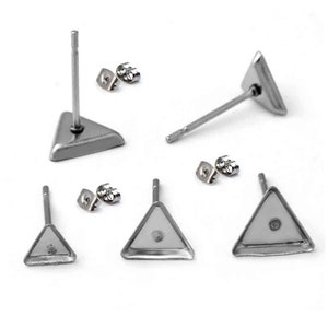 May include: A set of six silver triangle shaped earring studs. The earrings are made of metal and have a smooth, polished finish. The earrings are designed to be worn in the earlobe.