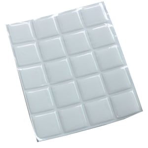 May include: A sheet of white, square-shaped, self-adhesive tiles. The tiles are arranged in a grid pattern and have a glossy, reflective surface. The sheet is on a white background.