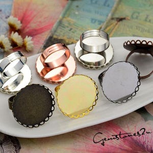 May include: Six different ring blanks with a variety of finishes, including silver, gold, and bronze. The blanks are round and have a raised edge. They are perfect for creating custom rings.