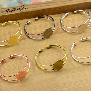 May include: Six double-layered bangle bracelets with a round, open-backed bezel setting. The bezels are available in gold, silver, and rose gold.