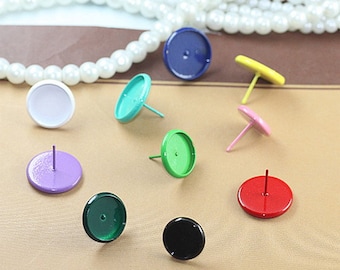 May include: Assortment of round, flat-backed cabochons with attached posts in various colors, including white, purple, green, blue, black, red, yellow, and pink.