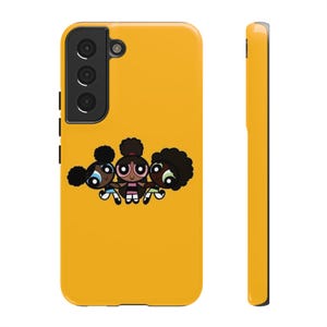 May include: A bright yellow smartphone case featuring a graphic illustration of three cartoon characters with dark skin and afro hairstyles, each wearing a different coloured outfit in blue, pink, and light green, holding hands in a row.