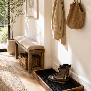May include: A rectangular dark wood boot tray with a black rubber grid insert, holding a pair of brown and tan duck boots. The tray features low sides and integrated handles, designed for organising footwear and protecting floors from moisture.