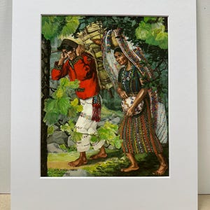 May include: A matted art print depicting two individuals walking through a wooded area. The person on the left wears a red jacket and white trousers, carrying a large bundle. The person on the right wears a colourful striped skirt and shawl. Text reads SAN MIGUEL CHICAJ.