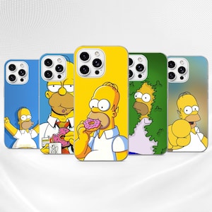 May include: Five smartphone cases featuring various illustrations of Homer Simpson. The designs include Homer cheering, eating a pink doughnut, emerging from a green hedge, and pointing forward. Each case has a cutout for a triple-lens camera system.