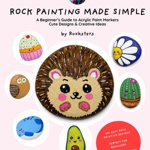May include: A book cover titled ROCK PAINTING MADE SIMPLE by Roxksters, featuring a guide to acrylic paint markers. The cover displays painted rocks including a hedgehog, cupcake, daisy, owl, cactus, whale, and avocado on a light pink background.