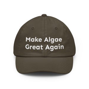 May include: A dark olive green baseball cap featuring the white embroidered text Make Algae Great Again centred on the front panel. The hat has a structured crown, a curved brim, and matching eyelets for ventilation on the top panels.