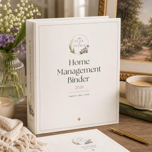 May include: A white home management binder with a floral logo and the text Plan & Petals Home Management Binder 2026 organise plan create. The spine features the text Home Management Binder 2026 and a floral illustration on a white cover.