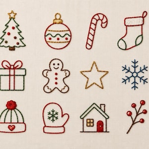May include: A collection of fifteen embroidered holiday icons on a light fabric background, including a Christmas tree, bauble, candy cane, stocking, holly, gift, gingerbread person, star, snowflake, bell, hat, mitten, house, berries, and wreath.