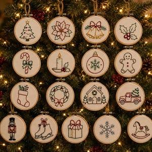 May include: A collection of fifteen circular embroidery hoops featuring festive holiday designs including a Christmas tree, poinsettia, bells, holly, candy cane, candle, ornament, gingerbread man, stocking, wreath, house, truck, nutcracker, skates, gift, snowflake, and rocking horse.