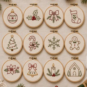 Puede incluir: Doce bastidores de bordado circulares de madera con tela blanca que presentan diseños navideños bordados, incluyendo una bola, acebo, lazo, calcetín, árbol, bastón de caramelo, copo de nieve, hombre de jengibre, flor de pascua, campana, vela y casa.