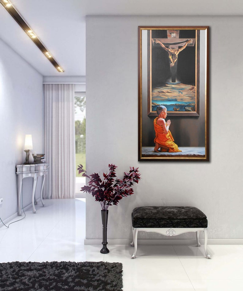 May include: A framed painting depicting a man on a cross with a monk kneeling in prayer in front of the cross. The painting is set against a dark background with a sky and clouds in the background.
