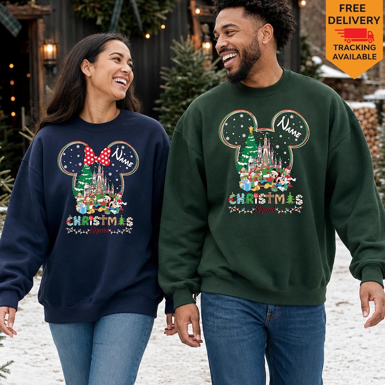May include: A navy blue sweatshirt and a dark green sweatshirt, both featuring a graphic of a Mickey Mouse ear silhouette containing a Christmas tree, a castle, and Disney characters. The text "Name" and "Christmas Squad" are printed on both.