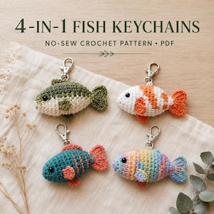 May include: Four crocheted fish keychains with metal lobster clasps. The fish are coloured in olive green and white, orange and white, teal and coral, and a pastel rainbow gradient. The text 4-IN-1 FISH KEYCHAINS NO-SEW CROCHET PATTERN PDF is visible.