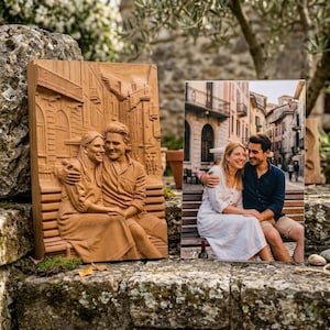May include: A rectangular wooden relief carving depicting a couple sitting on a bench in a city street, displayed next to a colour photograph of the same couple in the same pose, both showing the pair embracing on a bench in a European town.