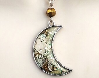 Crescent moon necklace in cream and bronze with sparkling iridescent and gold flecked enamel finish.