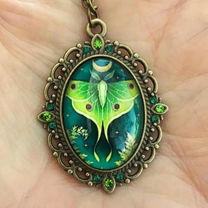 Large green luna moth and antique gold filigree oval shaped pendant necklace