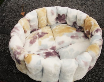 Round floral pet bed in white, tan and soft purple, machine washable and dryer safe