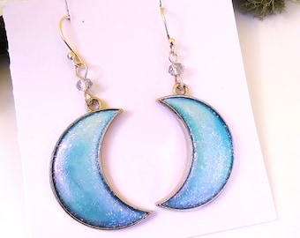 Crescent moon earrings in pastel watercolor blue, yellow, green, and turquoise