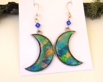Crescent moon earrings in pastel watercolor blue, yellow, green, and turquoise