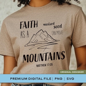 May include: A heathered tan short-sleeve t-shirt featuring a black graphic of a mountain range. The text reads: FAITH AS A mustard seed CAN MOVE MOUNTAINS MATTHEW 17:20. The design is centered on the chest of the shirt with a crew neckline.