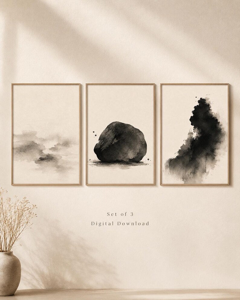 May include: A set of three framed wall art prints featuring black ink wash paintings on a beige background. The left print shows soft clouds, the centre print depicts a solid rock, and the right print displays an abstract ink splash. Text reads Set of 3 Digital Download.