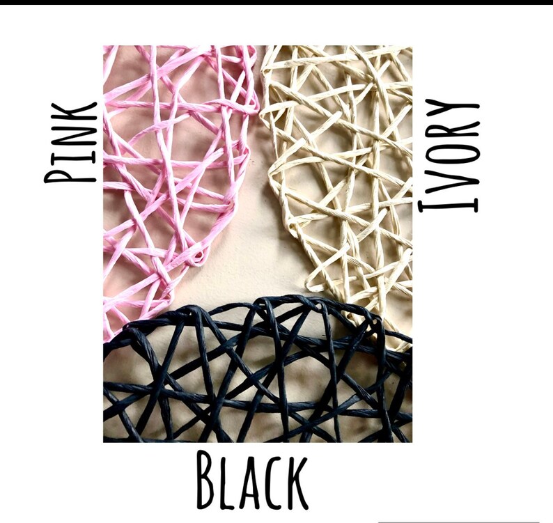 May include: Three heart-shaped woven wicker decorations in pink, ivory, and black.