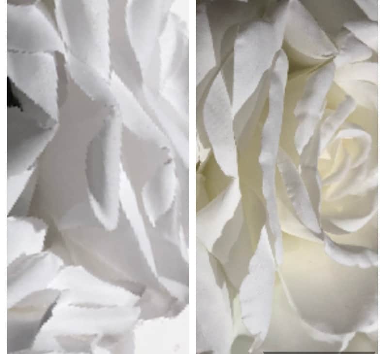 May include: A close-up view of a white artificial rose with layered, delicate petals. The flower features soft, matte-textured edges and a dense, spiraled center, showcasing a clean, monochromatic appearance with subtle shadows between the petals.