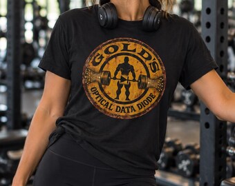 May include: A black short-sleeved t-shirt featuring a circular graphic with a distressed yellow background. The design depicts a silhouette of a person lifting a barbell, with the text GOLD'S OPTICAL DATA DIODE printed around the border.