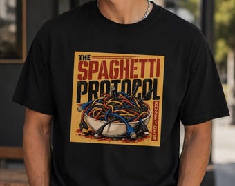 May include: A black short-sleeve t-shirt featuring a graphic print of a bowl filled with tangled colorful computer cables resembling spaghetti. The text reads THE SPAGHETTI PROTOCOL in bold letters, with additional Japanese characters on the right side.