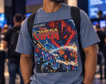 May include: A slate blue short-sleeve t-shirt featuring a graphic print of The Omega Virus board game box art. The design shows a menacing alien face, a globe with red network lines, and soldiers at computer monitors with the text: DESTROY IT NOW OR EARTH IS DOOMED!