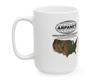 May include: A white ceramic mug featuring a black ARPANET logo, the text Advanced Research Projects Agency Network, and a satellite map of the United States showing research center locations including UCLA, SRI, and the University of Utah.