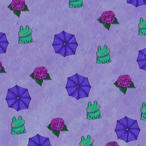 May include: A repeating pattern on a light purple background featuring green frogs with pink cheeks, dark purple umbrellas, and clusters of purple hydrangea flowers. Thin white diagonal lines represent falling rain across the entire surface.
