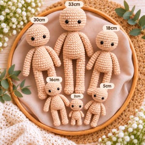 May include: Six beige crochet dolls with black bead eyes, arranged in a group. The dolls are labeled with heights of 33cm, 30cm, 18cm, 16cm, 5cm, and 2cm. Each doll features a round head, simple torso, arms, and legs made of yarn.