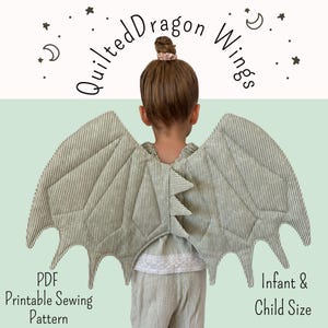 May include: Quilted dragon wings in a sage green and white pinstripe fabric. The wings feature a scalloped edge and a central spine with three triangular spikes. Text reads: Quilted Dragon Wings, PDF Printable Sewing Pattern, Infant & Child Size.