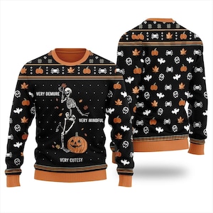 May include: A black long-sleeve jumper with orange trim featuring a skeleton graphic, a pumpkin, and the text "VERY DEMURE," "VERY MINDFUL," and "VERY CUTESY." The pattern includes orange maple leaves, white bats, spiders, and skulls on the front and back.