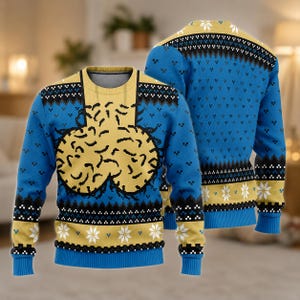 May include: A long-sleeve knit jumper featuring a blue and yellow colour scheme with a central yellow graphic of a brain. The design includes black and white geometric patterns, white snowflake motifs, and ribbed cuffs, collar, and hem.