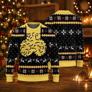 May include: A black and yellow long-sleeve jumper featuring a repeating pattern of white snowflakes, reindeer, and geometric shapes. The front displays a large, central yellow graphic with a textured, organic shape against a black background.